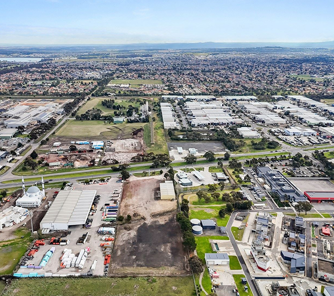 This aerial image showcases a vast, mixed-use urban landscape with a blend of industrial facilities, residential neighborhoods, and transportation infrastructure in the suburban area of Craigieburn. The presence of a conveyancer in this region suggests a thriving property market and demand for professional conveyancing services to support the local community.